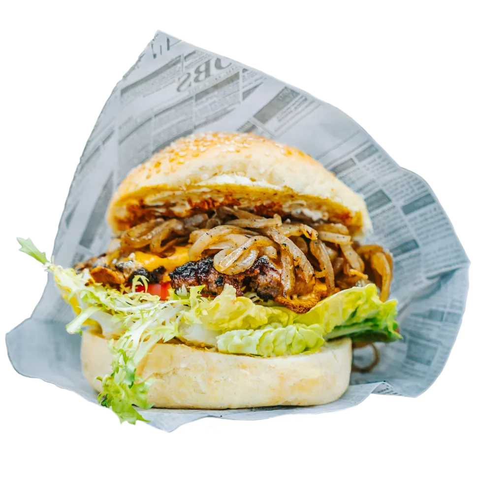 Saftiger Beef-Burger mit karamellisierten Zwiebeln, frischem Salat und Sesambrötchen – perfekter Genuss bei Foodliner.